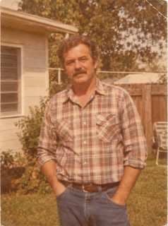 A faded 1980s print of a man in a plaid shirt standing in a yard